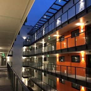 Vancouver apartment for rent - A modern building with orange and black balconies at 388 Kaslo East Village Apartments.