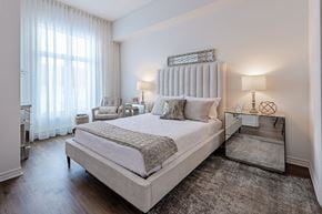 Pointe Claire apartment for rent - Spacious, modern bedroom with mirrored nightstand at La Voile Pointe-Claire apartments in Pointe-Claire, Quebec