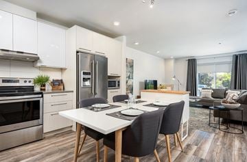 Brossard apartment for rent - a kitchen and living room with a table and chairs