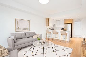 Vancouver apartment for rent - A modern living room with a grey sofa and a coffee table.