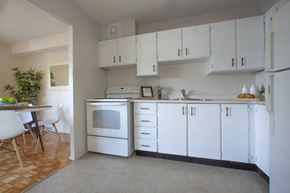 Cornwall apartment for rent - Kitchen with white appliances and white cabinets in a standard suite at Lorneville Apartments in Cornwall, ON