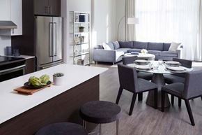 Cote Saint-Luc apartment for rent - A modern kitchen with a dining table set for two.