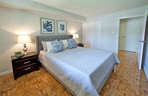 Whitby apartment for rent - A bedroom with a large bed and two lamps.