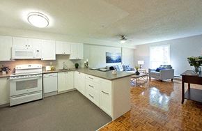 Whitby apartment for rent - A kitchen with white appliances and wooden floors.