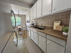 North York apartment for rent - A kitchen with white cabinets and a brown countertop.