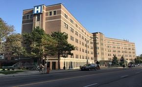 Toronto apartment for rent - A hospital building with a blue letter H on top.