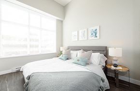 New Westminster apartment for rent - Bedroom with open blinds, allowing the sunlight to filter onto the bed