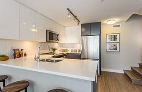 New Westminster apartment for rent - Full kitchen with ample lighting and view of the stairs