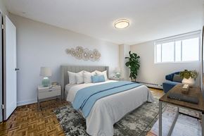 Bradford apartment for rent - Primary bedroom, with a queen size bed and side tables and sliding window with blackout roller blinds at Park Place Apartments in Bradford, ON