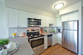 Whitby apartment for rent - Contemporary kitchen with white cabinetry and stainless steel appliances in Whitby, ON