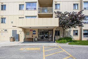 Chatham apartment for rent - Main building entrance as seen from parking lot at Riverbend Tower Apartments in Chatham, ON