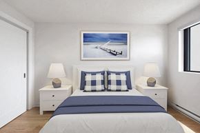 Chatham apartment for rent - Primary bedroom with queen size bed at Riverbend Tower Apartments in Chatham, ON