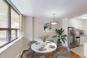 London apartment for rent - A dining room with a table set for four in a renovated 2 bed 1.5 bath suite at Somerset Place in London, ON.