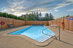 St. Thomas apartment for rent - Sunset Towers outdoor pool with full-enclosed wood fence in St. Thomas, ON