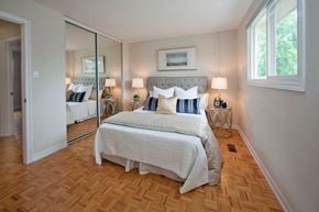 Barrie townhouse for rent - Tamarack Woods Bedroom with mirrored door closet and natural lighting through large windows in Barrie, ON