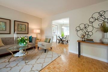 Barrie townhouse for rent - A living room with a glass coffee table and a grey sofa.