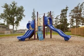 Barrie townhouse for rent - Tamarack Woods playground, showing play structure with slides and climbing wall in Barrie, ON