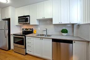 Oshawa apartment for rent - Taunton Terrace modern kitchen with white cabinetry and stainless steel appliances