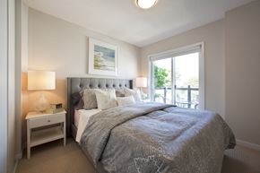 North York apartment for rent - Towns on the Ravine Bedroom with grey covers and access to the balcony