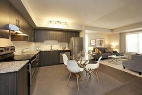 North York apartment for rent - Towns on the Ravine Kitchen with dark wood cabinets and specked stone counters