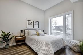 Waterloo apartment for rent - a bedroom with a bed and a large window at Vale Station Apartments in Waterloo ON