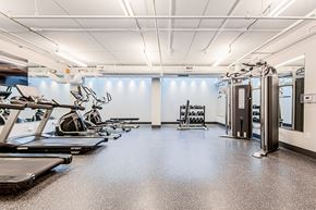 Waterloo apartment for rent - Gym with treadmills and elliptical cardio machines and weight lifting equipment at Vale Station Apartments in Waterloo, Ontario