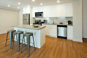St. Catharines apartment for rent - Waverly Place modern kitchen with white cabinetry and island in St. Catharines, ON