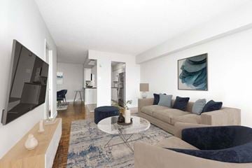Aurora apartment for rent - A living room with a blue rug and a grey sofa.