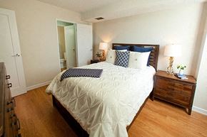 Barrie apartment for rent - Edgehill Apartments in Barrie, ON Bedroom with neatly made bed and two nightstands that have two lamps on ether side