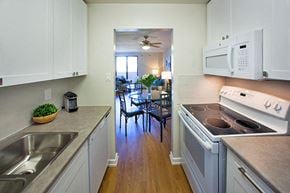 Collingwood apartment for rent - Mountain View View from kitchen to dining room and living room. A stove, microwave, cupboards and sink are visible in Collingwood, ON