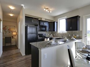 Airdrie apartment for rent - Airdrie Place in Airdrie, AB Open concept kitchen-dining area lit by sunlight