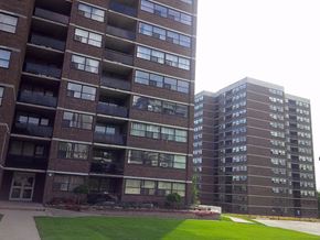 Toronto apartment for rent - two apartment buildings are next to each other on a street