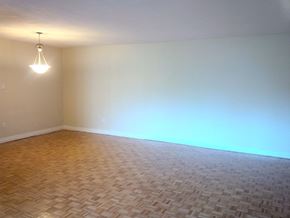 Toronto apartment for rent - an empty living room with a light on the wall