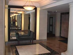 Toronto apartment for rent - a lobby with a chair and a glass table