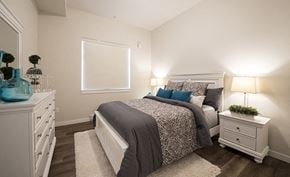 Nanaimo apartment for rent - A bedroom with a bed, nightstand, and dresser.
