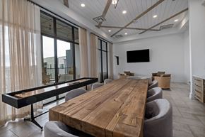 Wake Forest apartment for rent - A conference room with a long wooden table and chairs.
