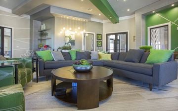 Orlando apartment for rent - A modern living room with a dark wood coffee table and grey couches.