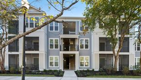 Mt. Pleasant apartment for rent - A modern apartment building with a tree in front.