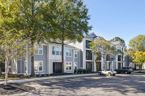 Mt. Pleasant apartment for rent - A modern residential building with a parking lot in front.