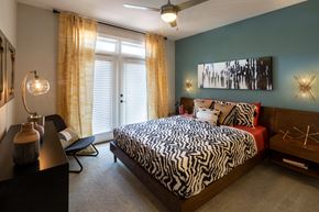 Atlanta apartment for rent - a bedroom with a bed with a zebra print comforter