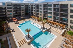 Atlanta apartment for rent - a rendering of a pool with chairs and a building in the background