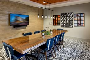 Atlanta apartment for rent - a dining room with a wooden table and blue chairs