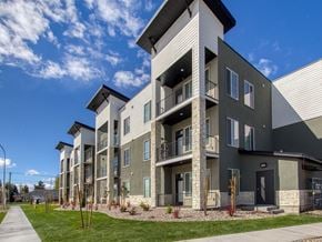 Idaho Falls townhouse for rent - A modern apartment building with a well-maintained lawn in front.