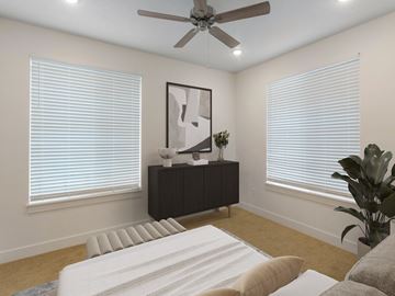 Logan apartment for rent - A modern living room with a white sofa and a ceiling fan.