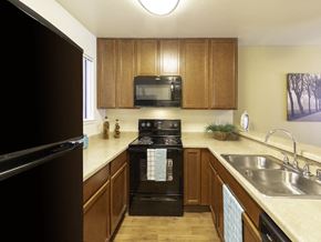 Sacramento apartment for rent - California Place Kitchen with Black Appliances