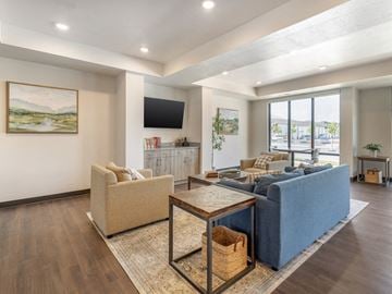 Logan apartment for rent - the living room of a new home with a blue couch and a table