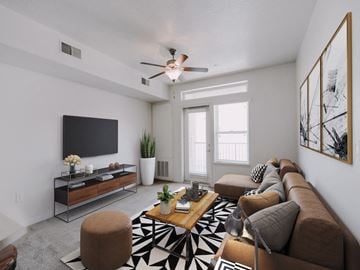 Salt Lake City apartment for rent - the living room of an apartment with a couch and a ceiling fan