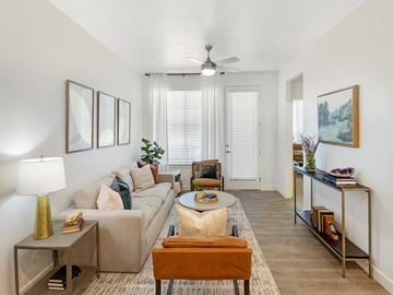 Syracuse townhouse for rent - a living room with a couch and a ceiling fan