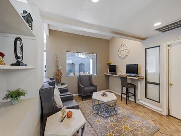 Glendale apartment for rent - A living room with a grey couch, a white coffee table, and a television on the wall.