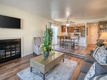 Fresno townhouse for rent - A living room with a fireplace and a television mounted on the wall.